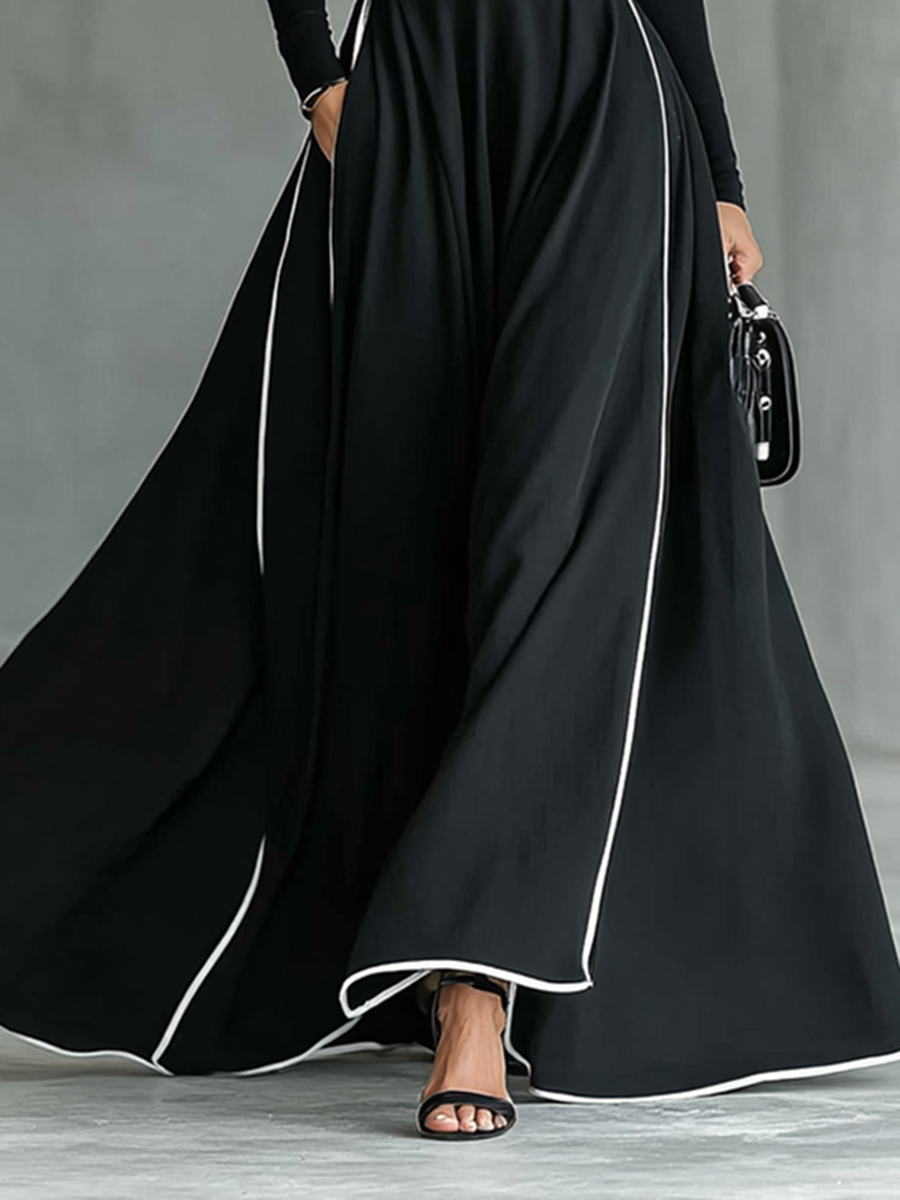 Gina – Vestido largo negro de mujer con costuras blancas, cuello alto, mangas largas y cintura ajustada