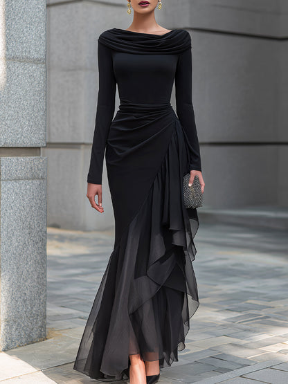 Vestido largo tipo sirena negro, con hombros descubiertos, cuello vuelto, mangas largas, volantes de gasa y corte drapeado