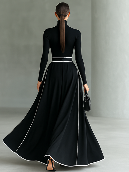 Gina – Vestido largo negro de mujer con costuras blancas, cuello alto, mangas largas y cintura ajustada