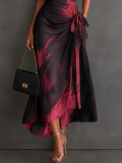 Vestido midi cruzado con estampado abstracto en rojo y negro, cuello en V, manga corta, lazo en la cintura y volantes en el bajo asimétrico